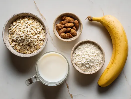 Banana, oats, and almond milk displayed on kitchen surface