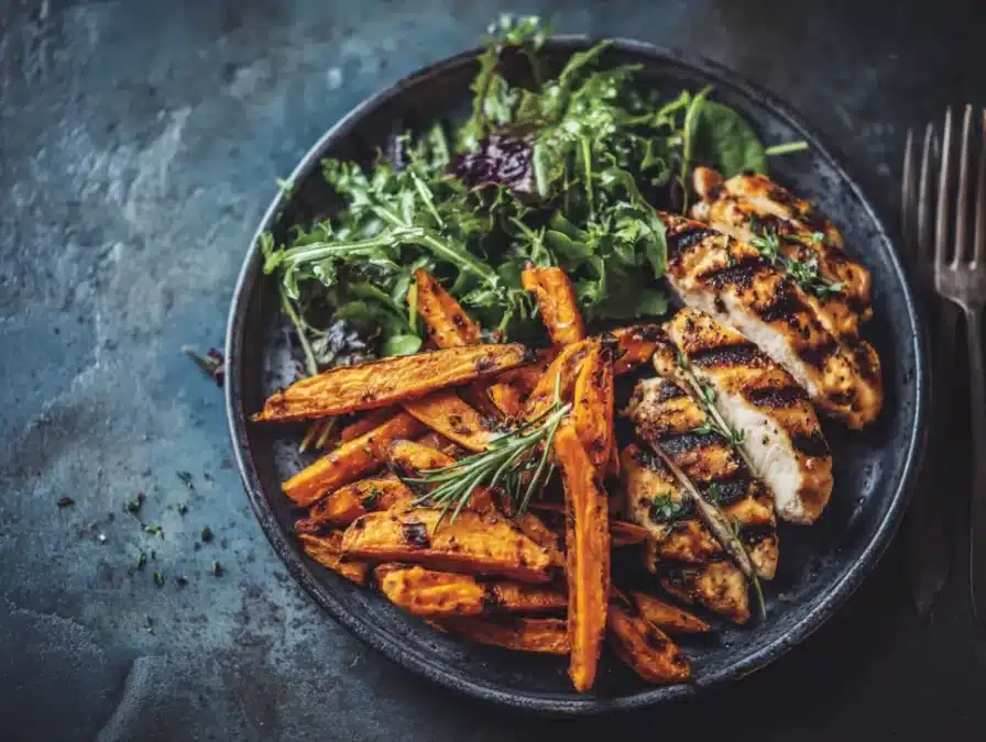 Sweet potato fries with chicken and salad
