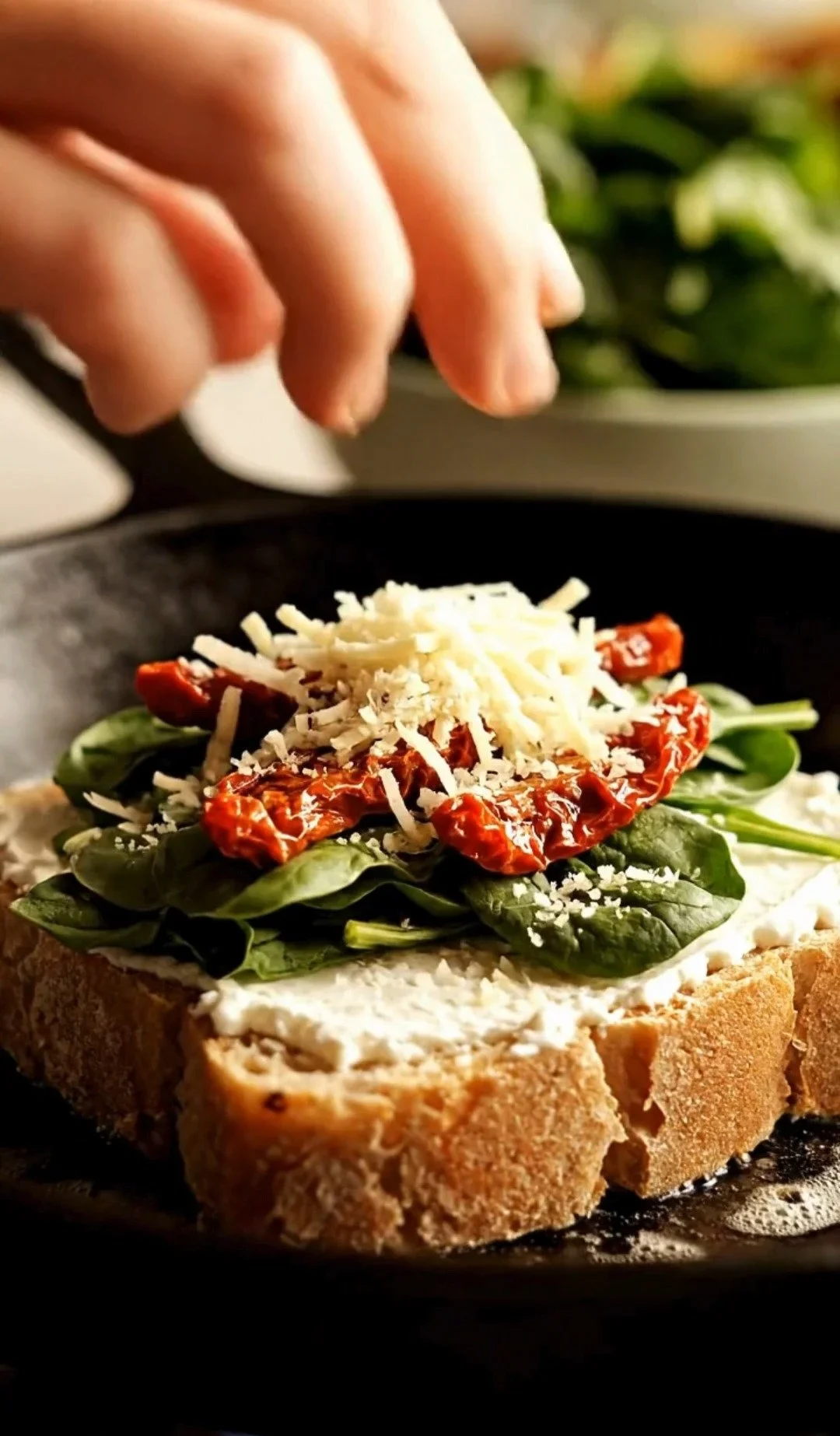 Sun-dried tomato, spinach, and ricotta grilled cheese sandwich on a plate