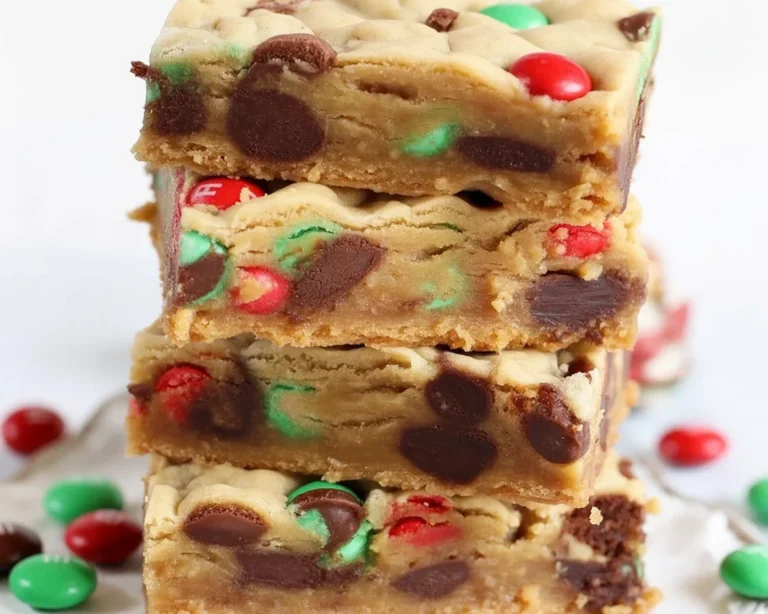 Soft and chewy Christmas M&M cookie bars loaded with festive M&Ms and chocolate chips.