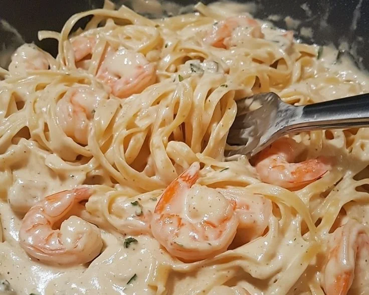 Creamy Boursin shrimp pasta garnished with herbs