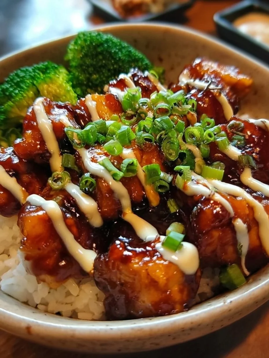 Sticky Chicken Rice Bowls with tender chicken and sticky rice, garnished with herbs.