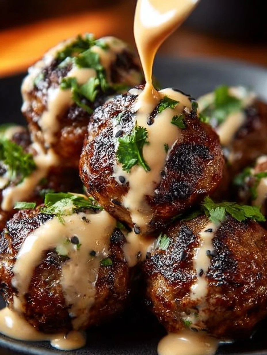 Korean BBQ meatballs served with spicy mayo dip on a platter.