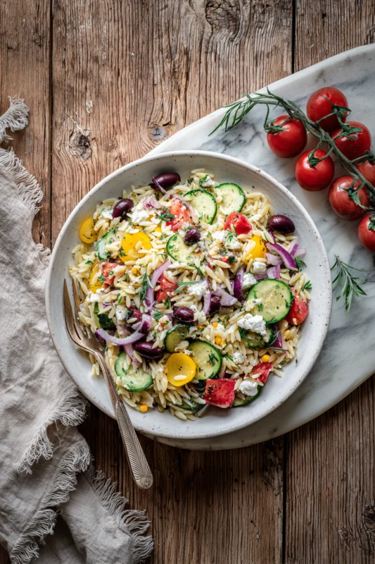 Mediterranean Orzo Salad: 5-Minute Mediterranean Delight with roasted vegetables and herbs in a baking dish